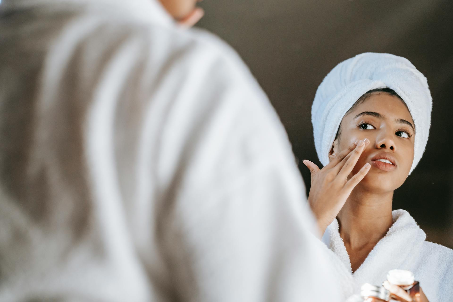 Woman applying K-beauty skincare to her face